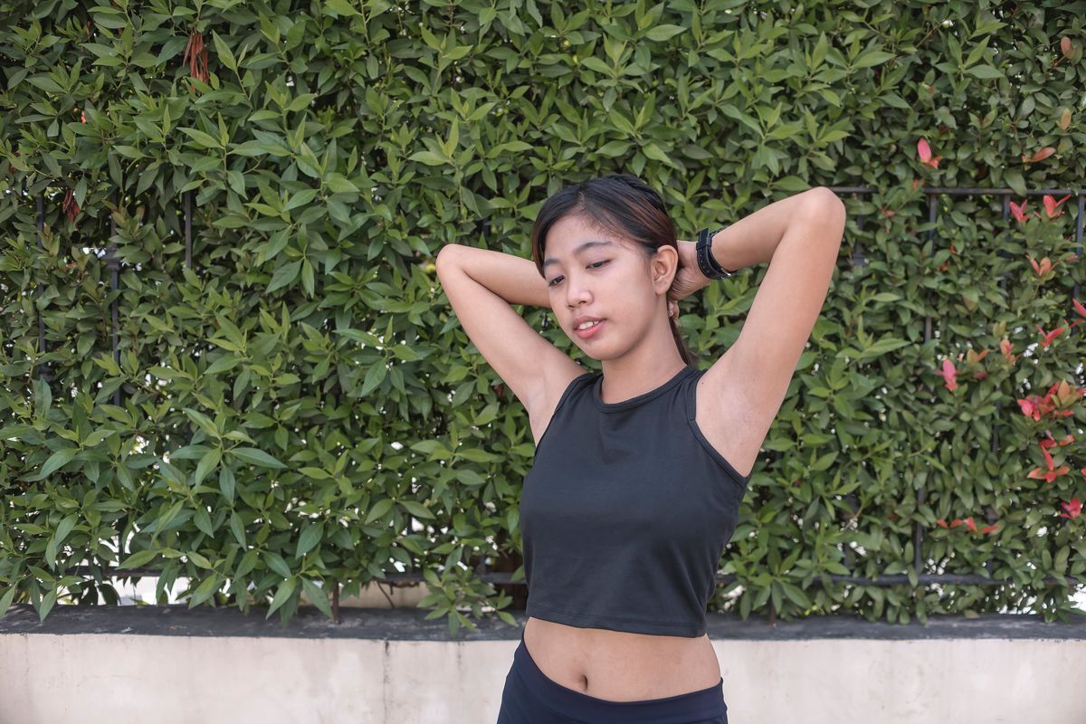 Asian woman holding up arms