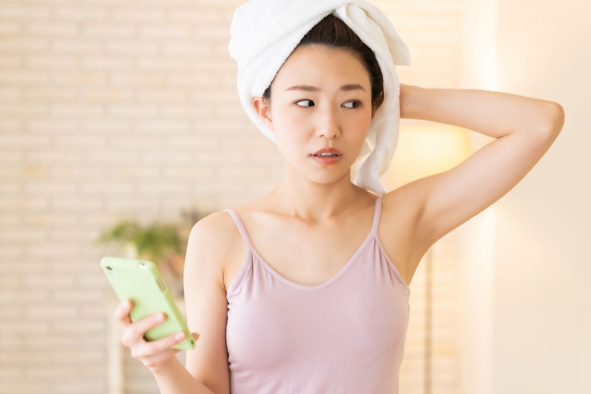 Woman towel drying her hair.