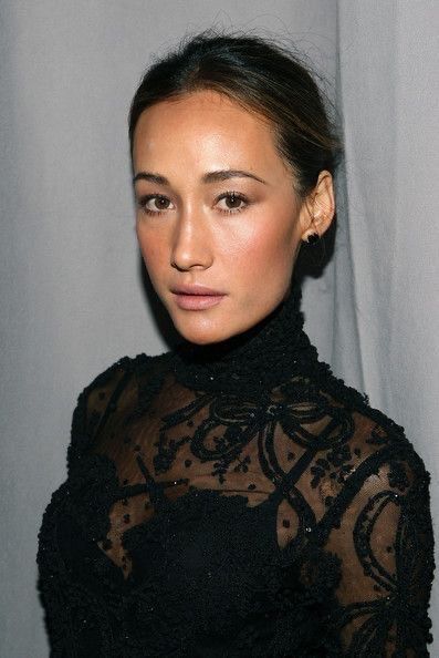 A close-up of Maggie Q with black dress.