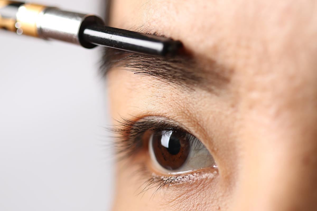 Woman grooming her eyebrows