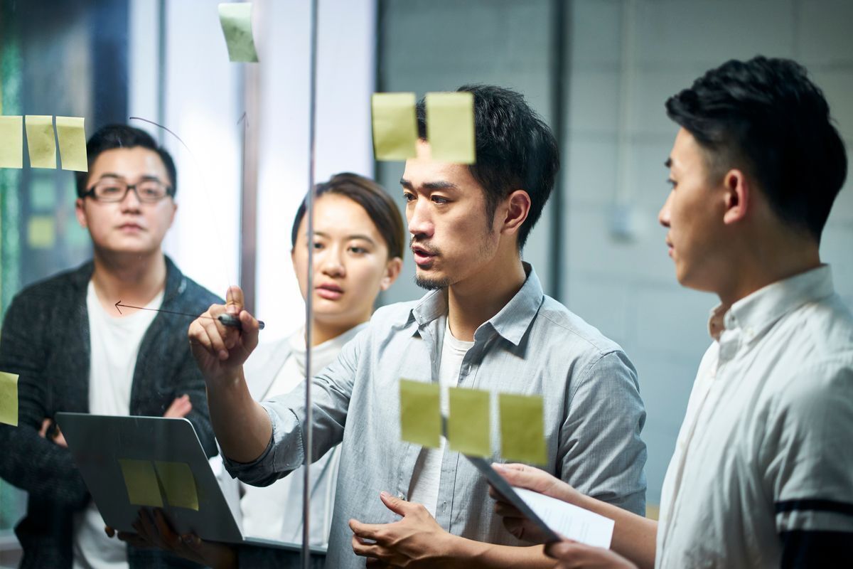 A group of young employees working together during a team meeting.
