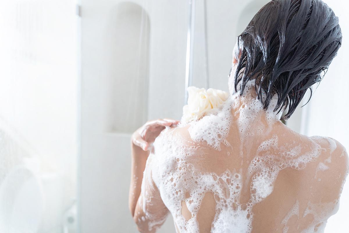 Back of Asian woman taking a shower