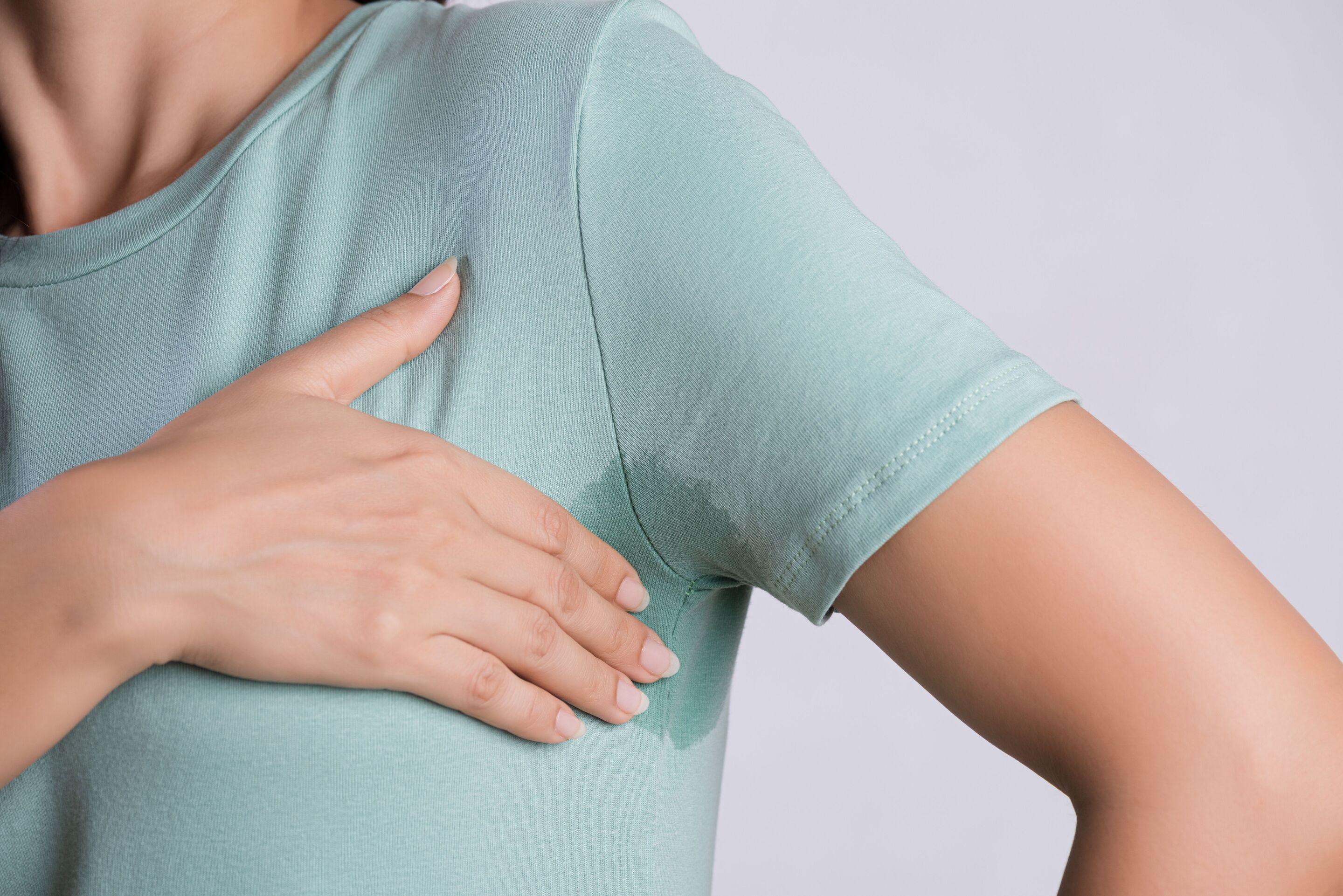 Underarm sweat stain on a green shirt