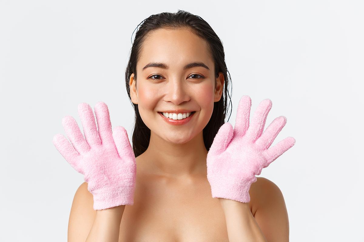 Woman wearing pink bath gloves