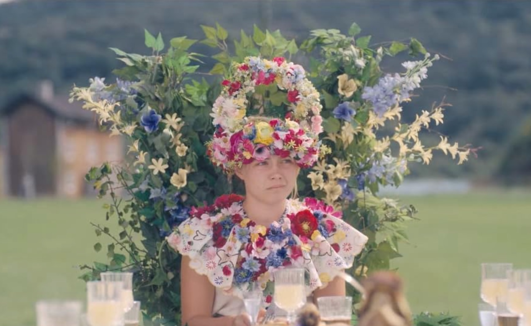 An exaggerated flower crown works best for this ensemble from Midsommar. (Source: IMDB)