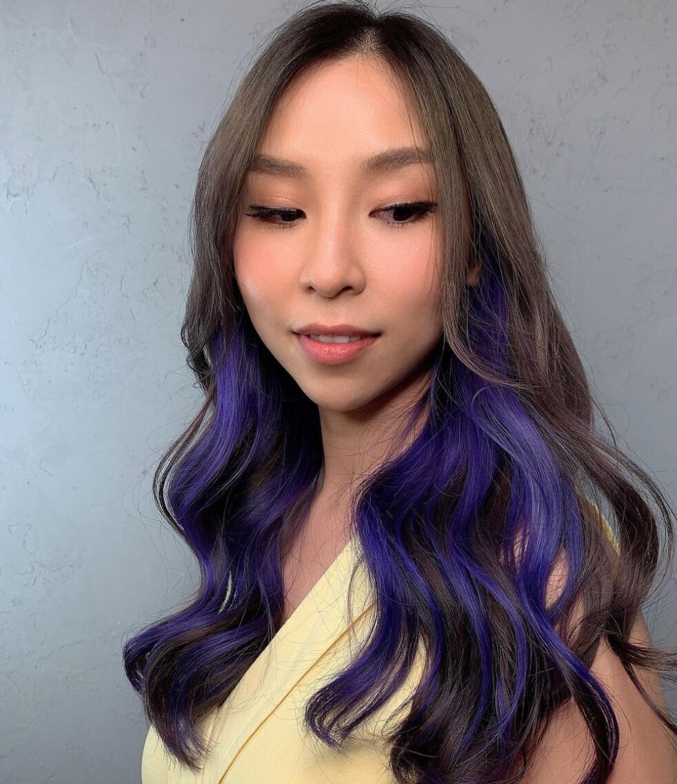 A woman with neon green highlights on her long hair