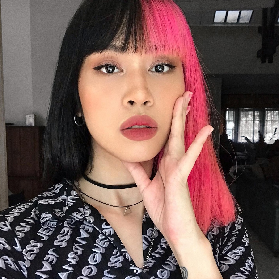 A woman with half and half hair color and blunt bangs