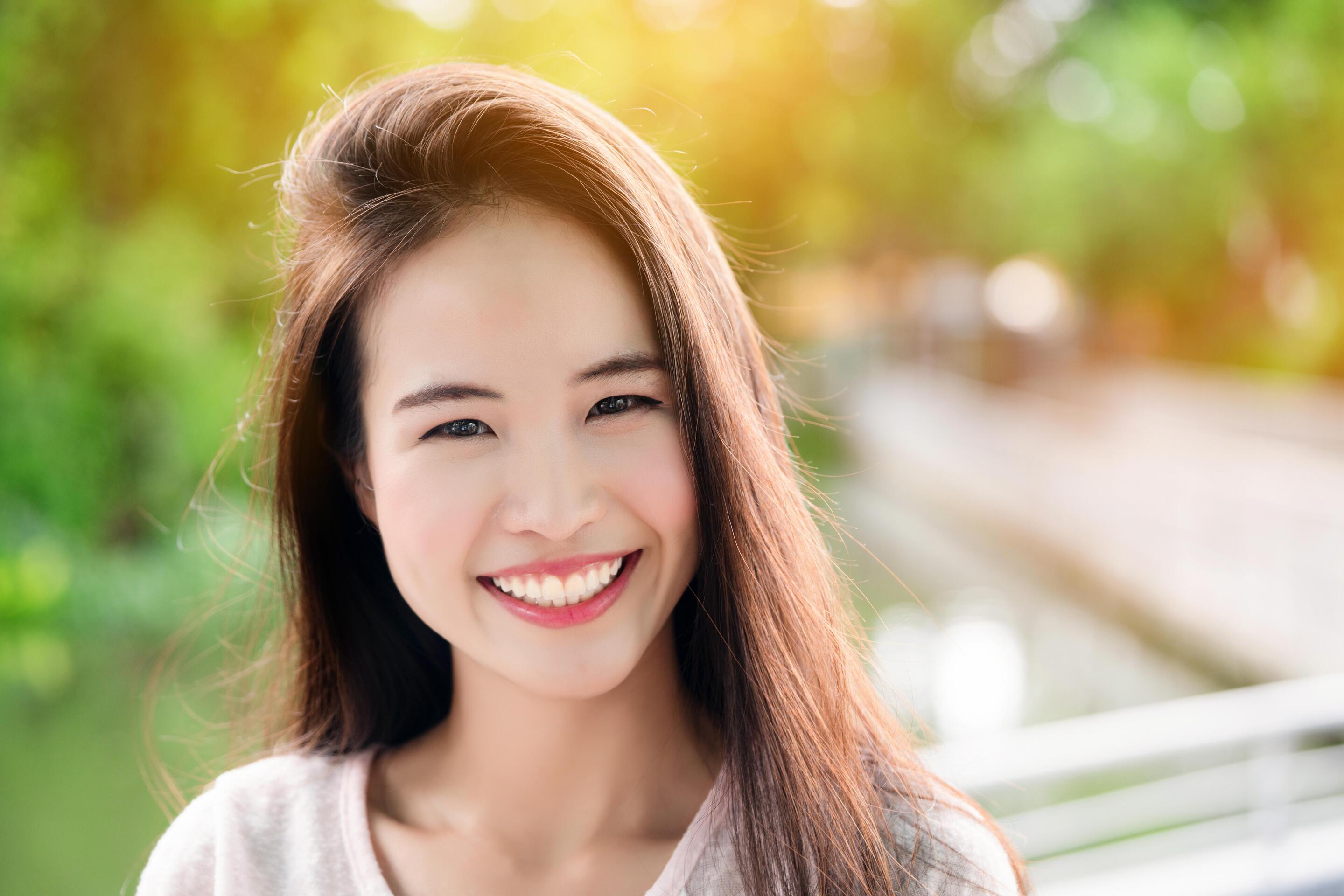 A woman with rosy cheeks smiling