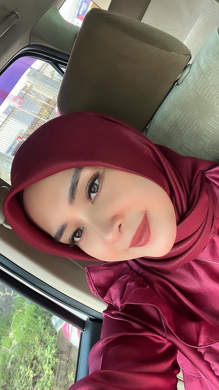 A portrait of woman with red hijab.