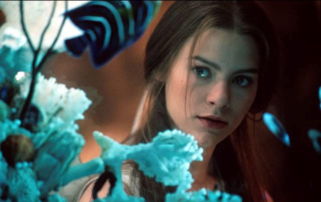 Claire Danes looking through an aquarium