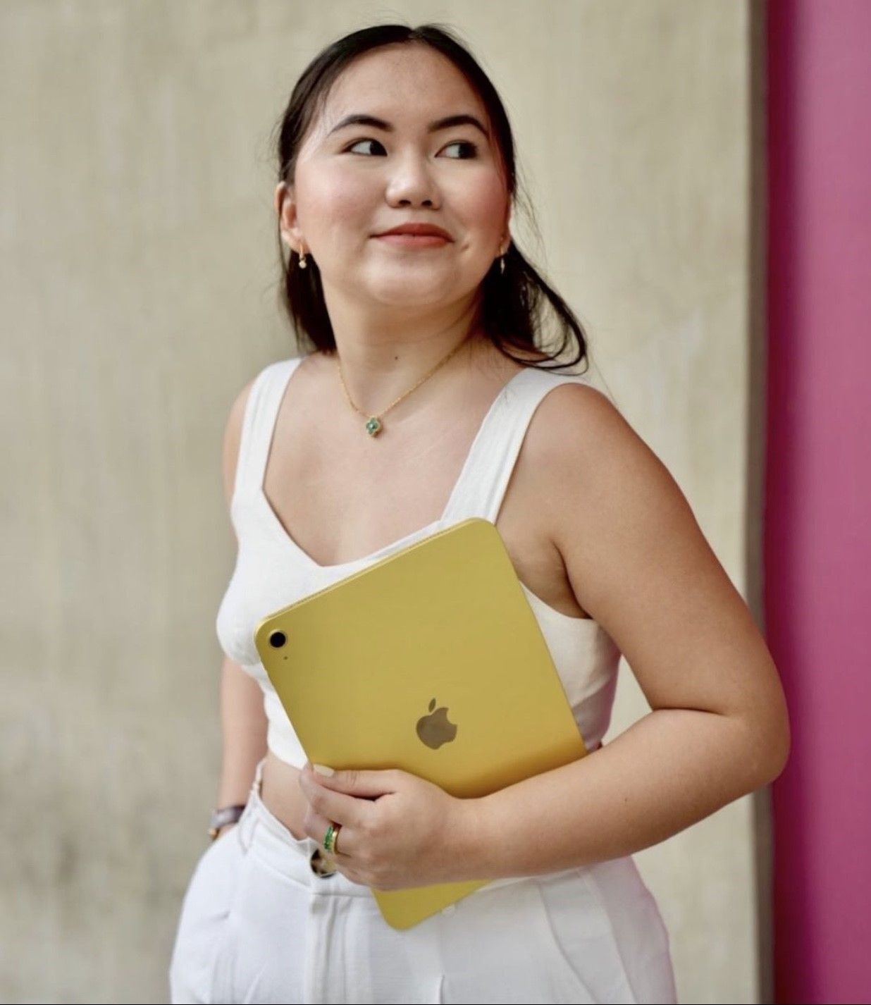 Asian woman leaning her head on her hand and smiling 