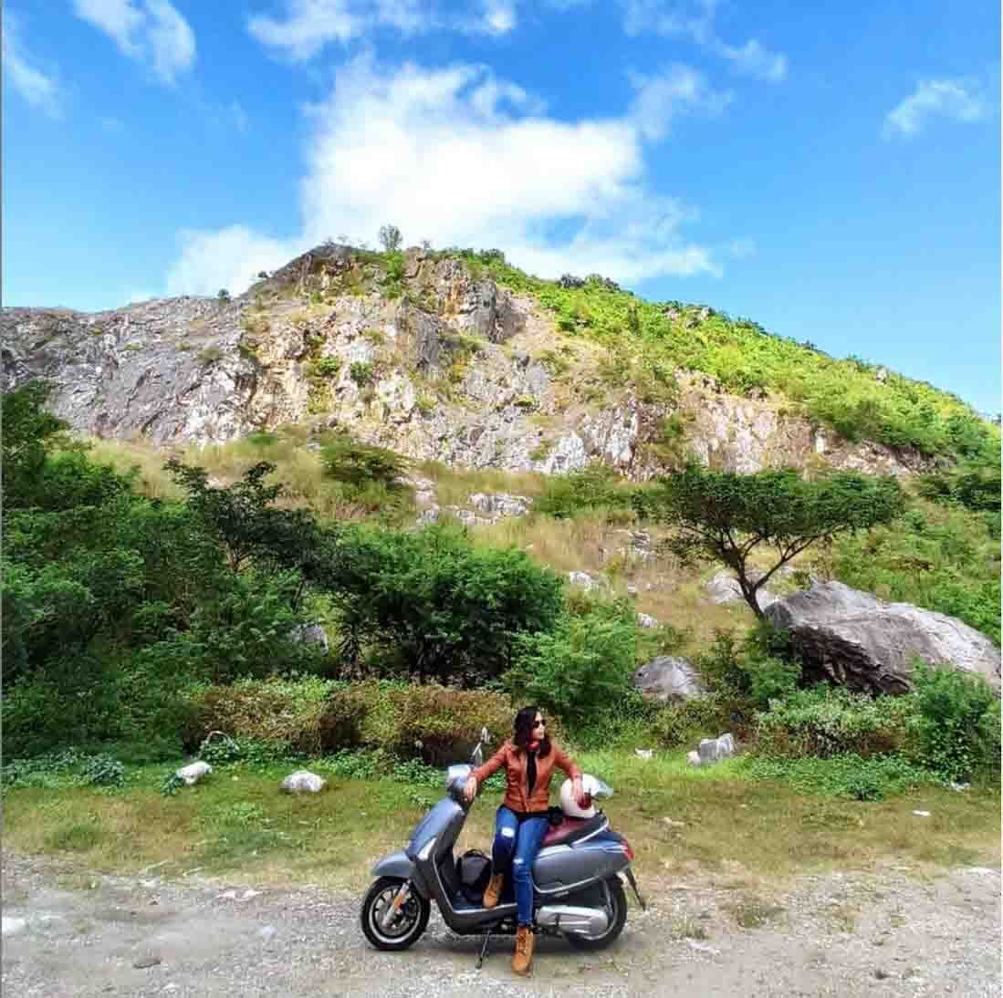 A woman on her motorbike in the mountains
