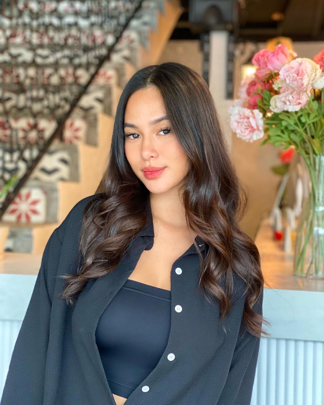 Woman with long and wavy brown hair.
