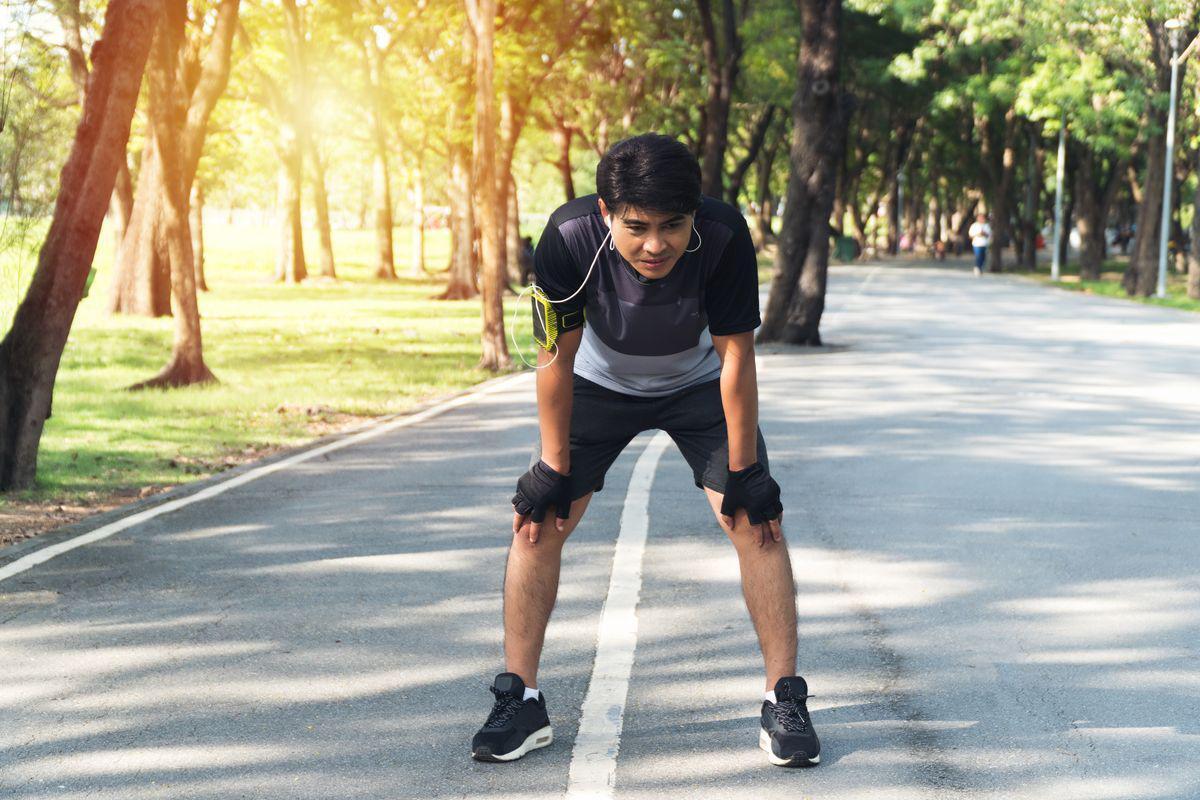Asian man resting after run