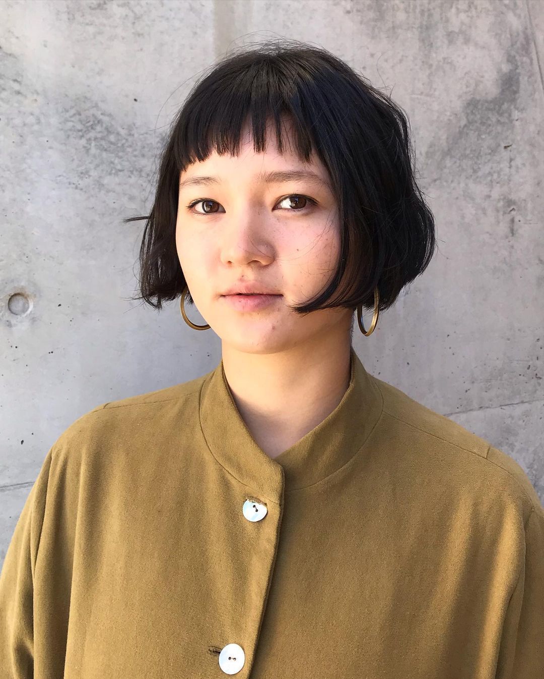 Woman with French bob and micro bangs.