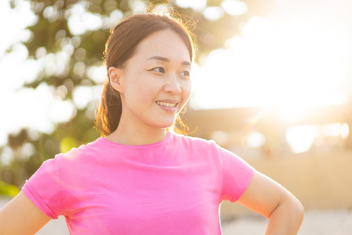 Asian woman in pink shirt working out