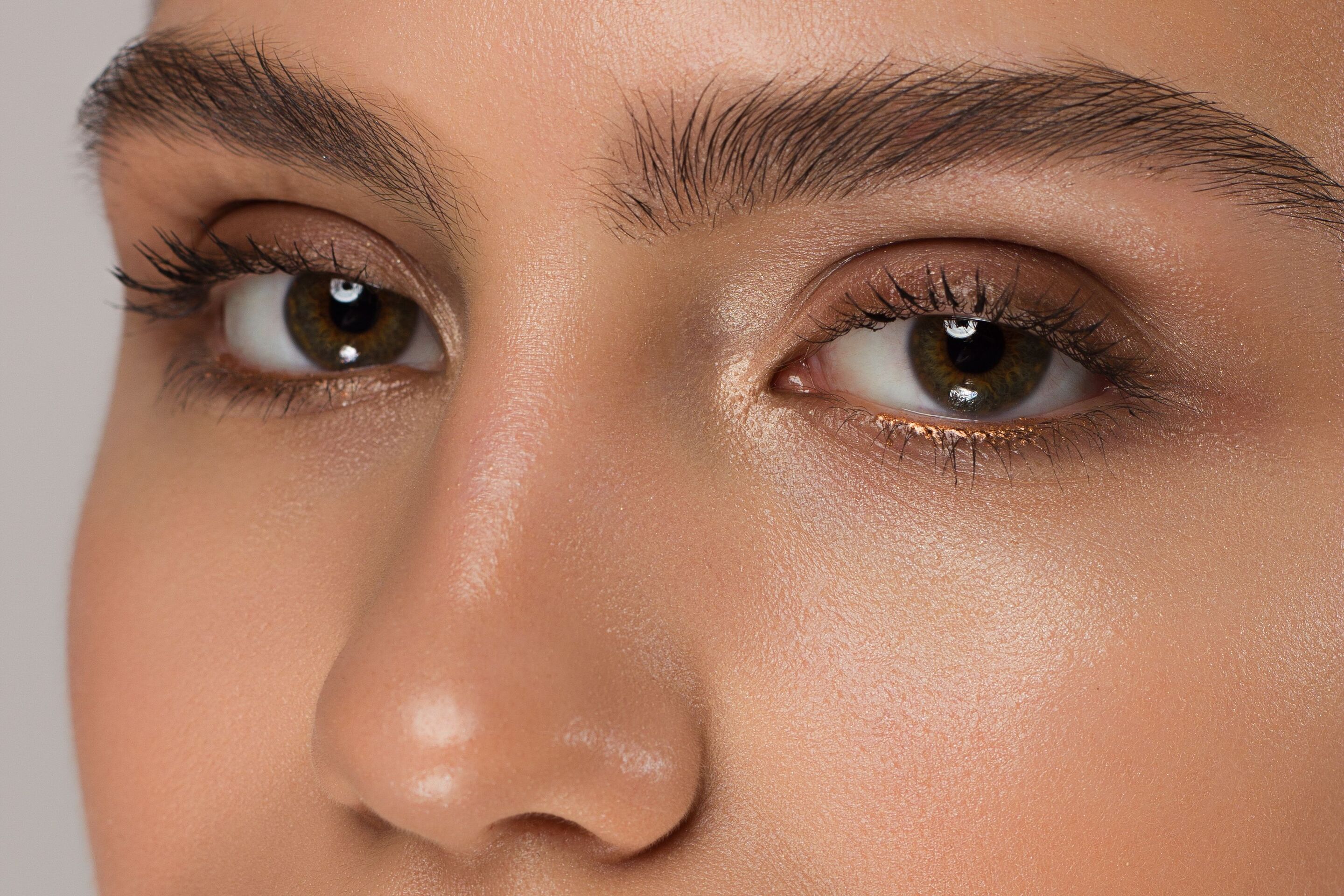 Closeup of a woman’s eyes with makeup and thick eyebrows
