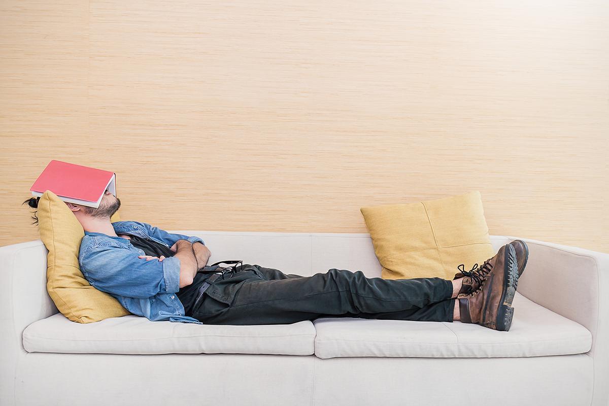 Man sleeps on his sofa.