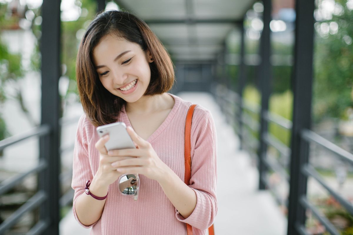 Asian woman looking at her phone