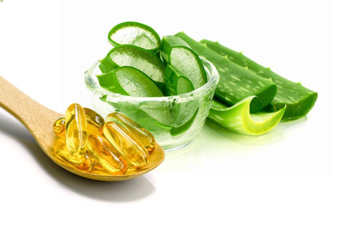 Vitamin E capsules and sliced aloe vera