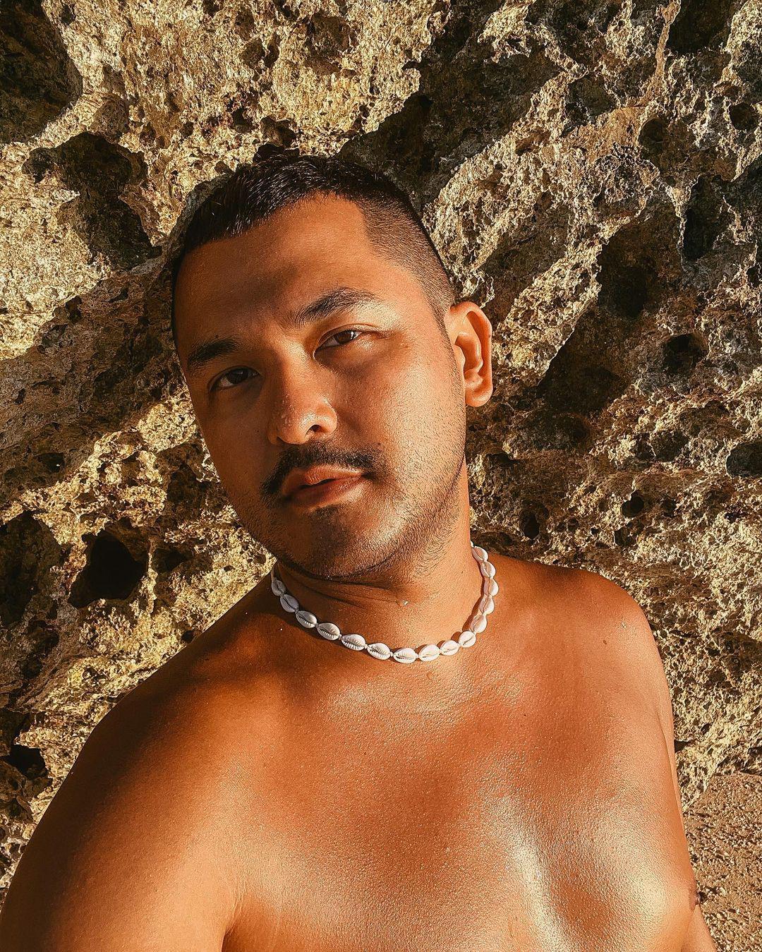 Asian man with glowing skin outdoors