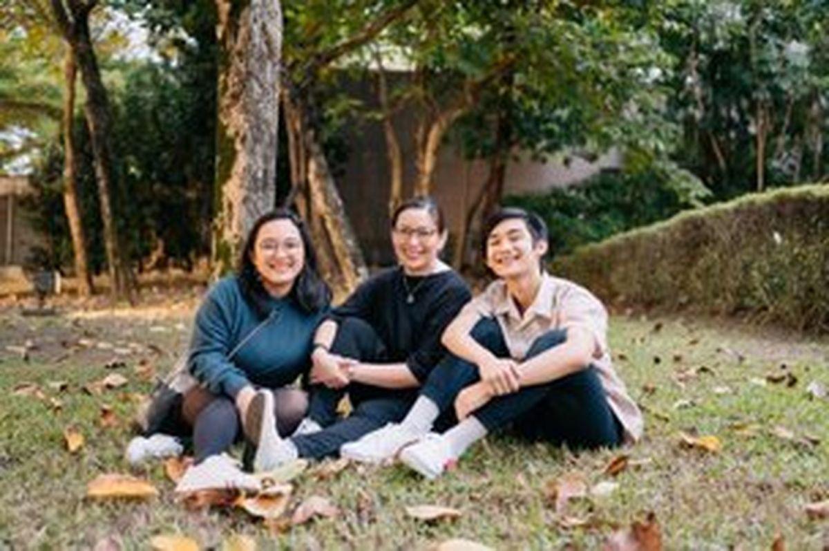 Asian mom with teenage kids outside 