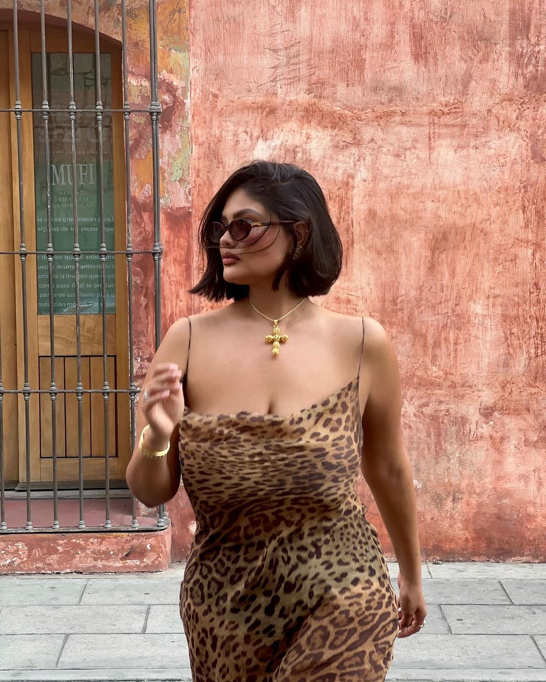 A portrait of woman wearing a slip dress with leopard print.