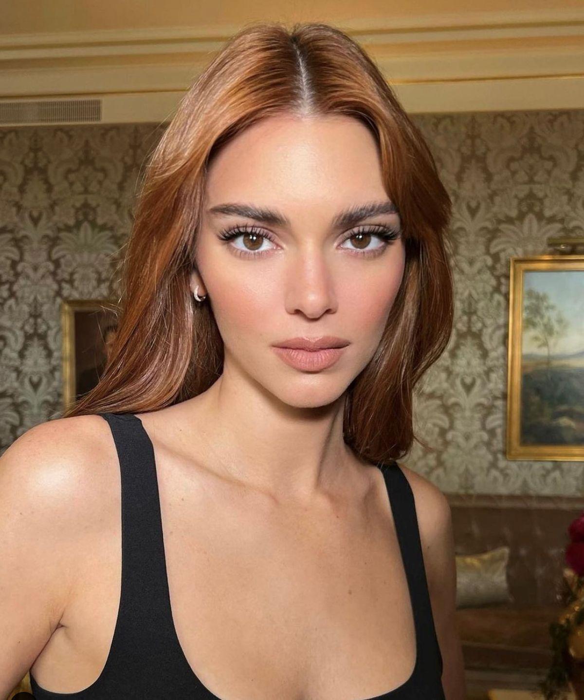 Woman in black tank top looking at the camera 