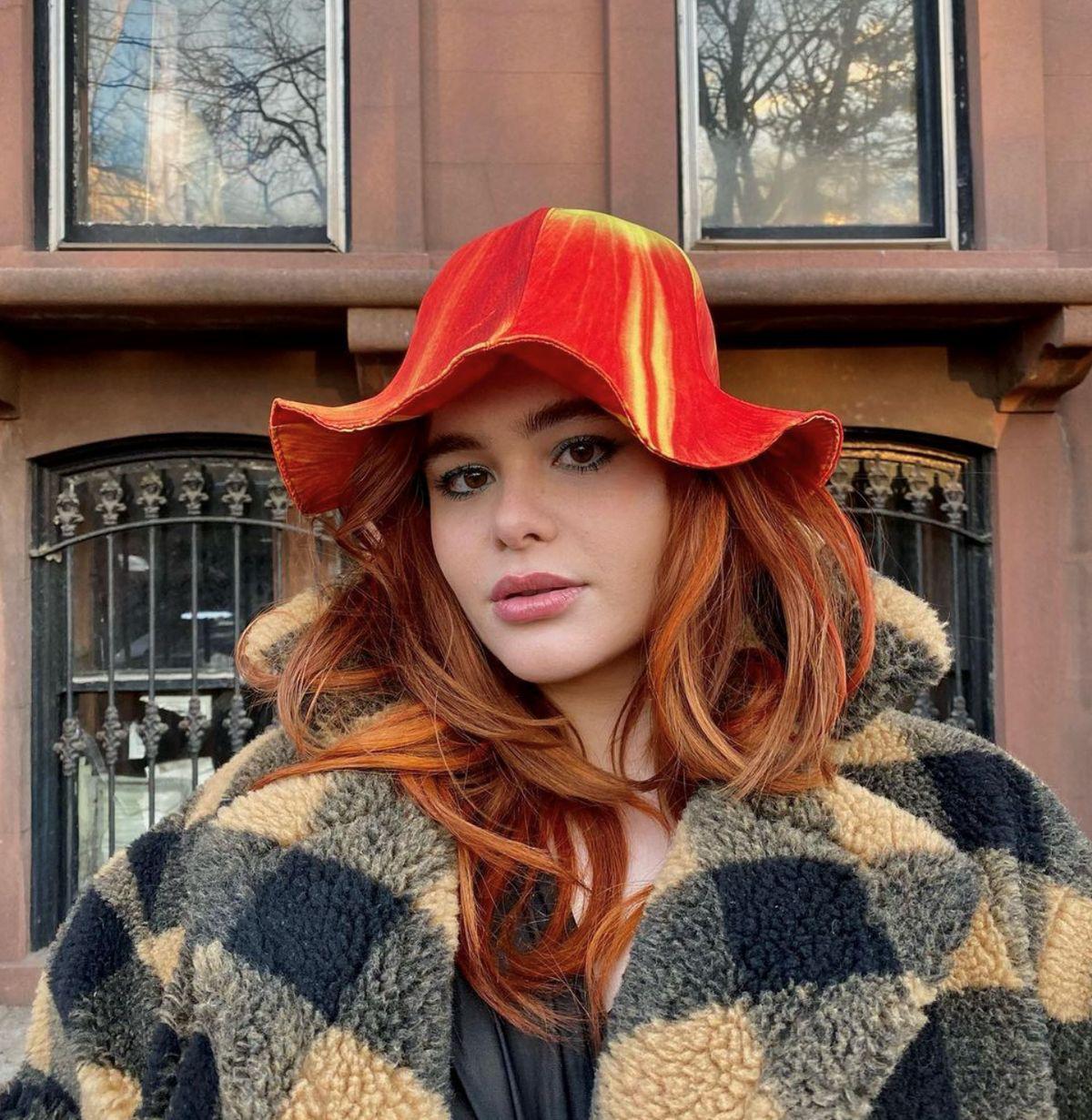 Woman with a red hat and checkered coat 