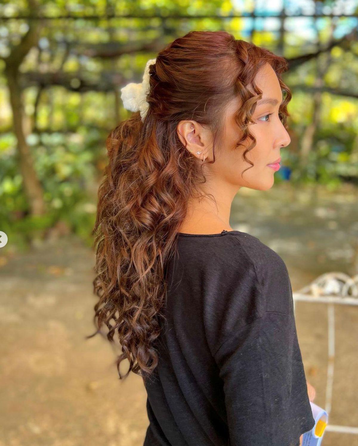 Asian woman with copper curly hair  