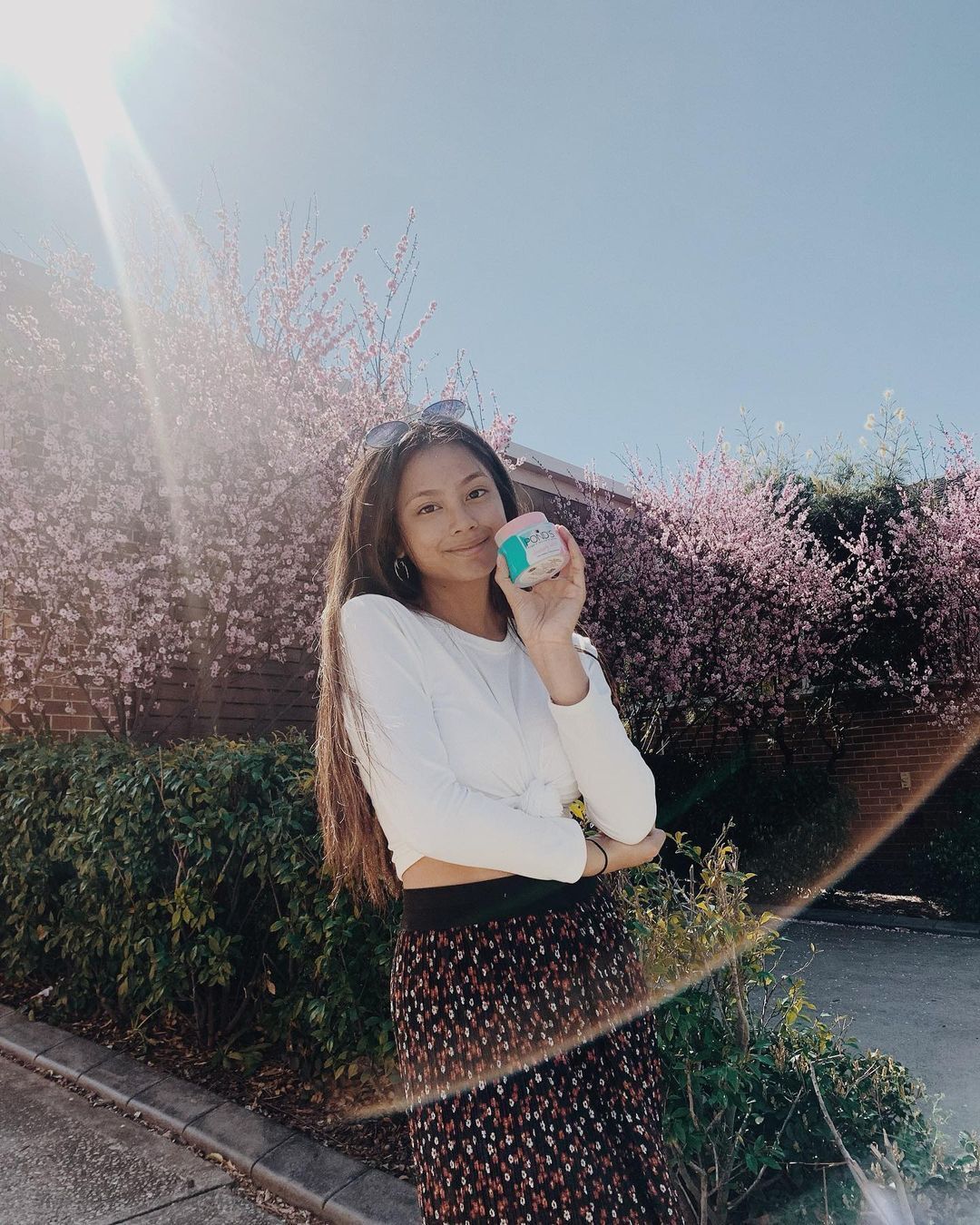 Ylona Garcia outdoors holding POND's Cleansing Balm