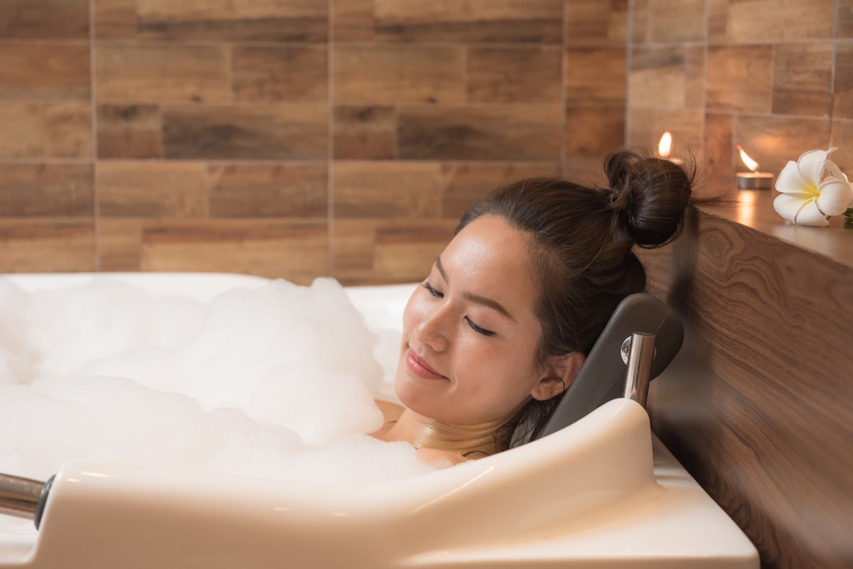 Filipino woman relaxing in a bubble bath