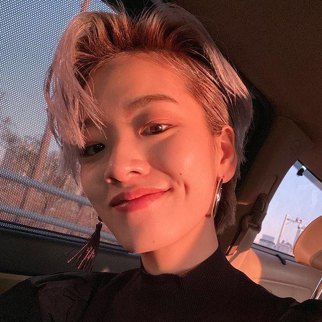 Asian woman with short pink hair