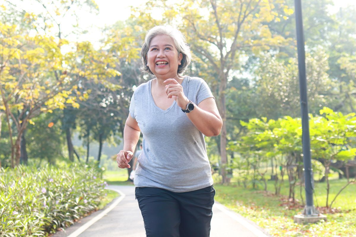 Elderly Asian woman jogging in the park in the morning