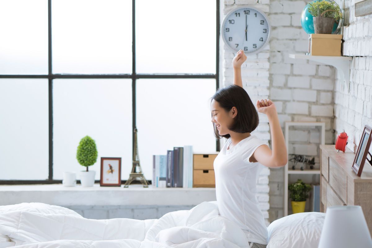 Asian woman waking up early