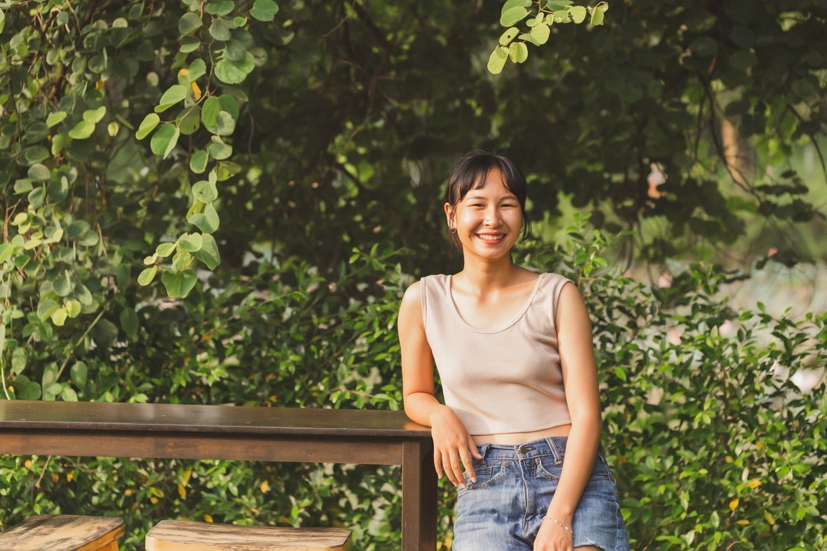 Asian woman at a park smiling