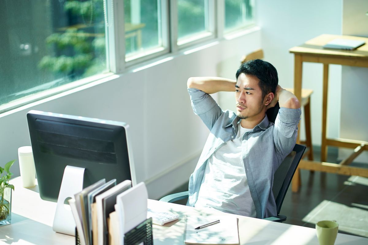 A man sitting at a desk while deep in thought