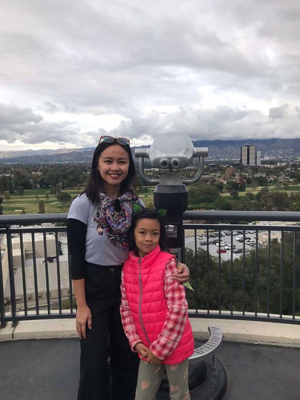 Asian mom with daughter in pink jacket 