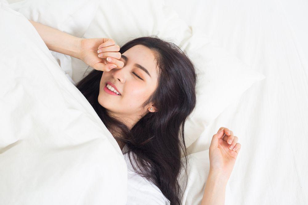 Asian woman waking up