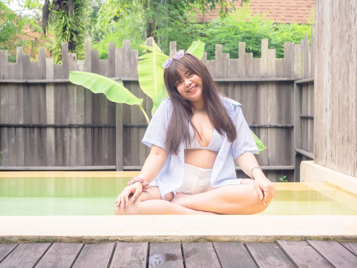 Woman in a swimsuit posing in front of the camera.