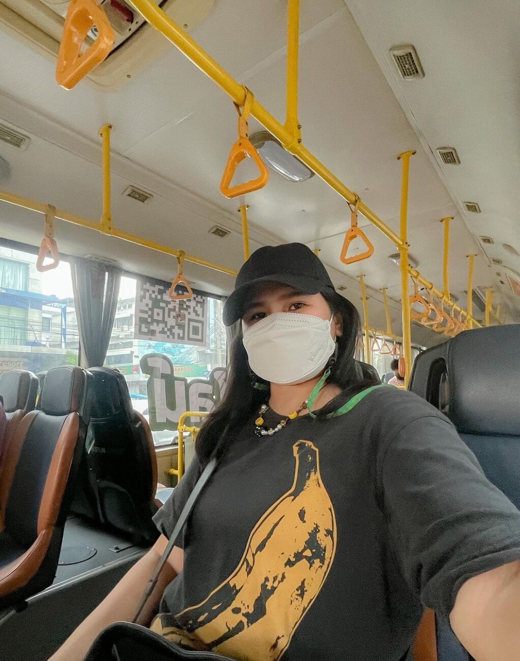 Asian woman wearing a mask on a train in Thailand.