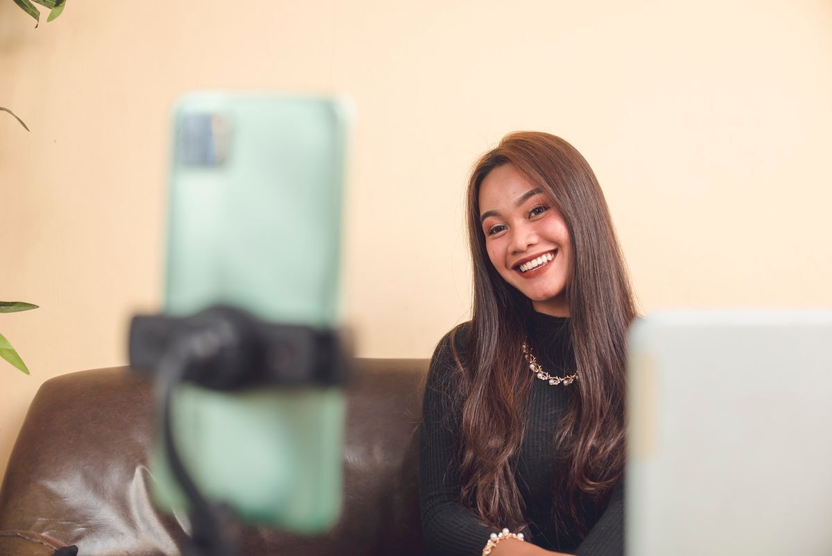 Filipino woman taking a photo with self timer 