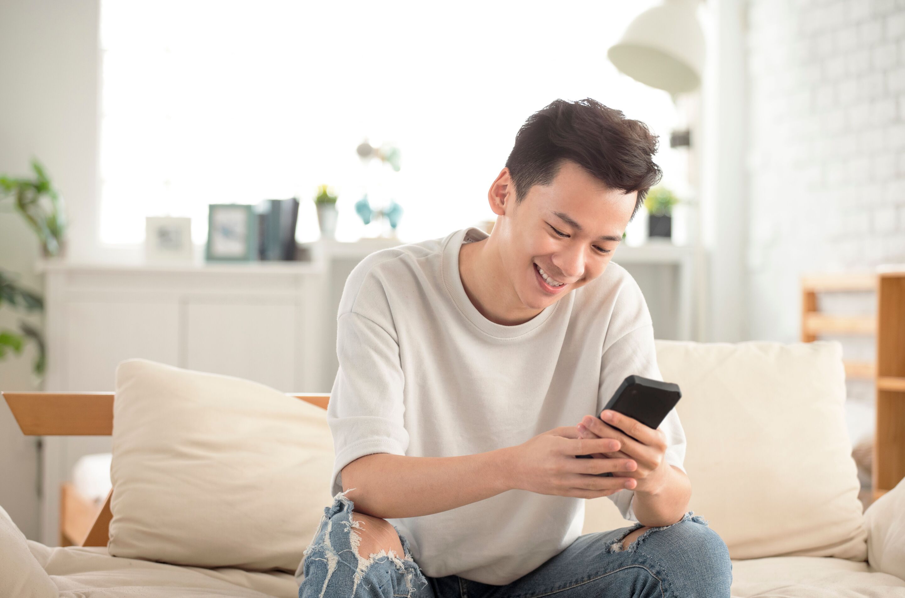 Asian man looking at phone