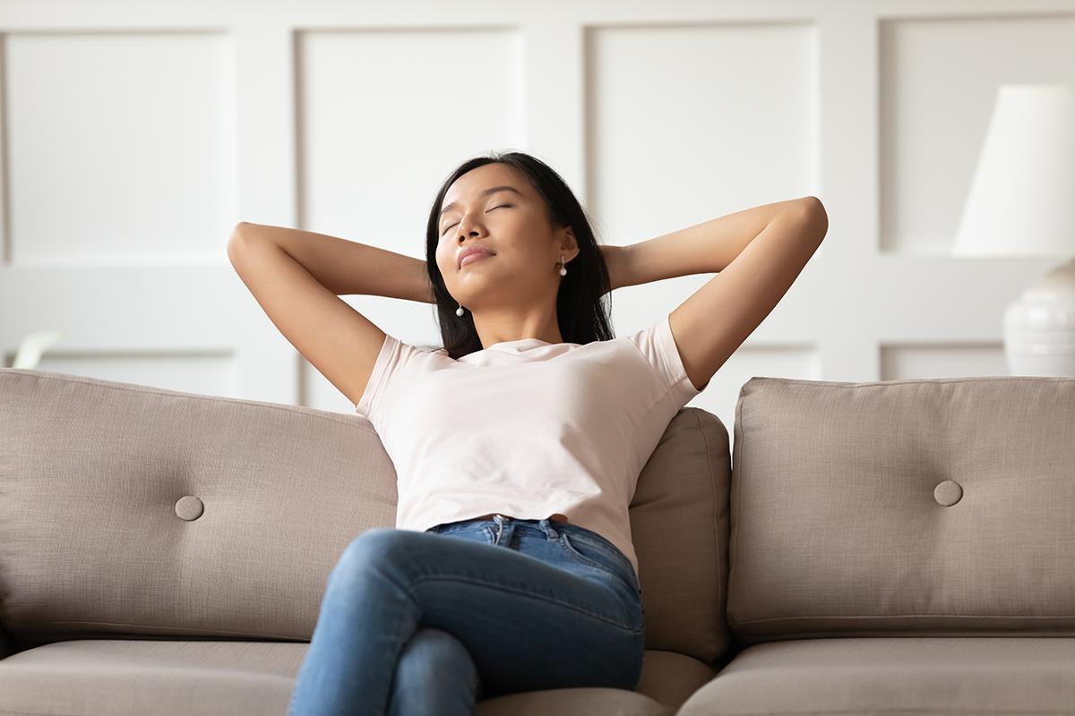 Asian woman taking a nap on sofa