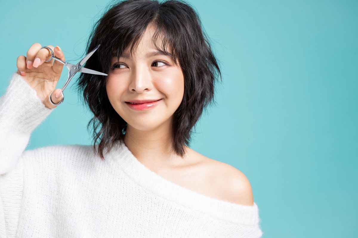 Asian woman with layered shag hairstyle and bangs 
