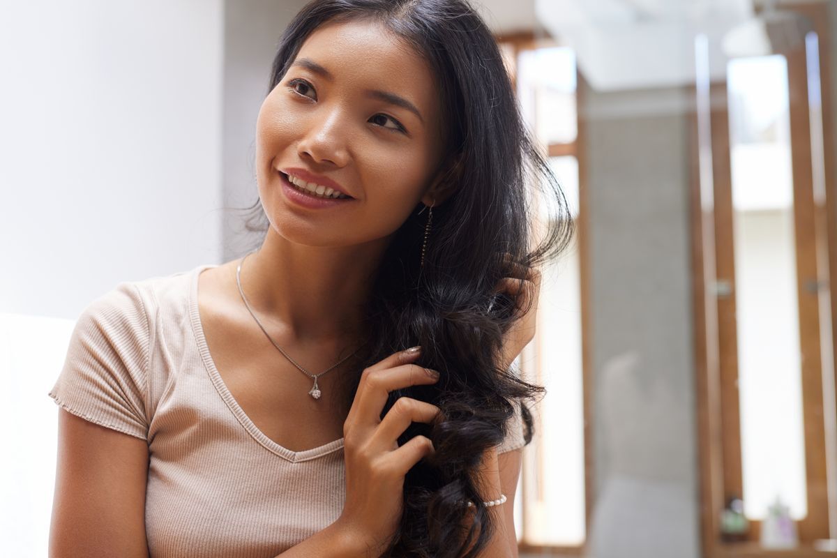 Young Asian woman with long wavy hair