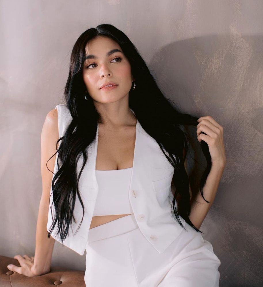 Actress Andrea Torres with long layered hair.