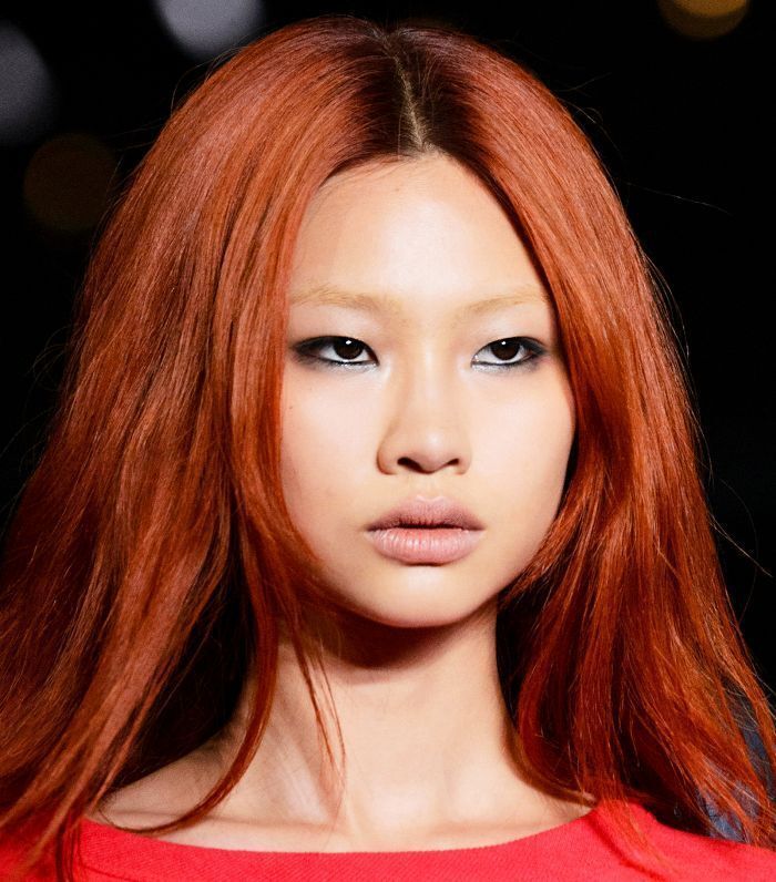 Asian supermodel with copper orange red hair.
