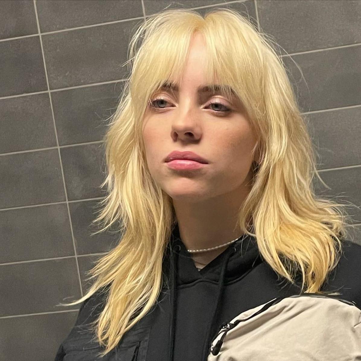 Billie Eilish with a blonde shag haircut