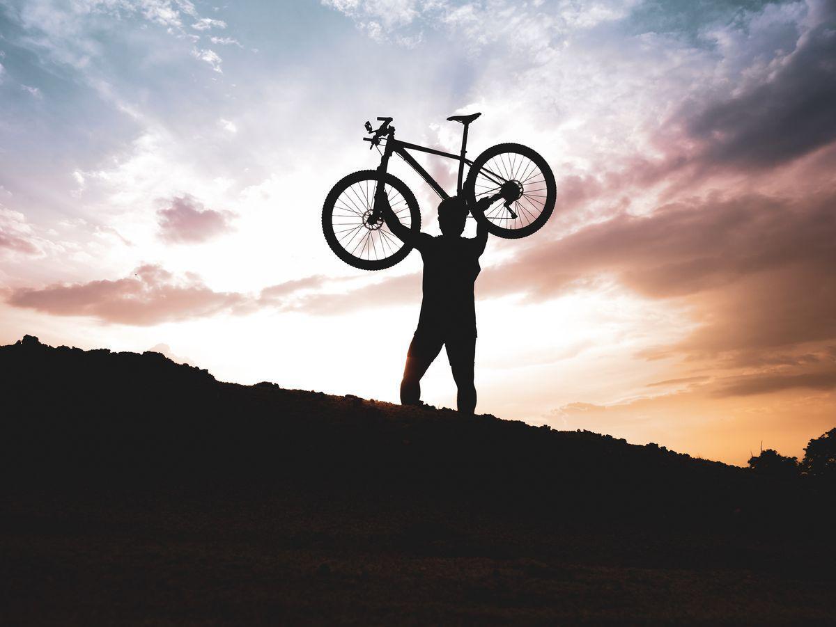 Man holding bike on mountain